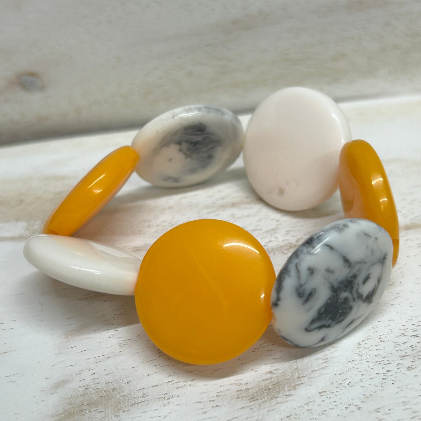 Elasticated resin disc bracelet by Suzie Blue- Yellow, White and smokey grey.