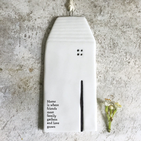 Home is where friends meet family gathers & love grows. Hanging ceramic house sign.