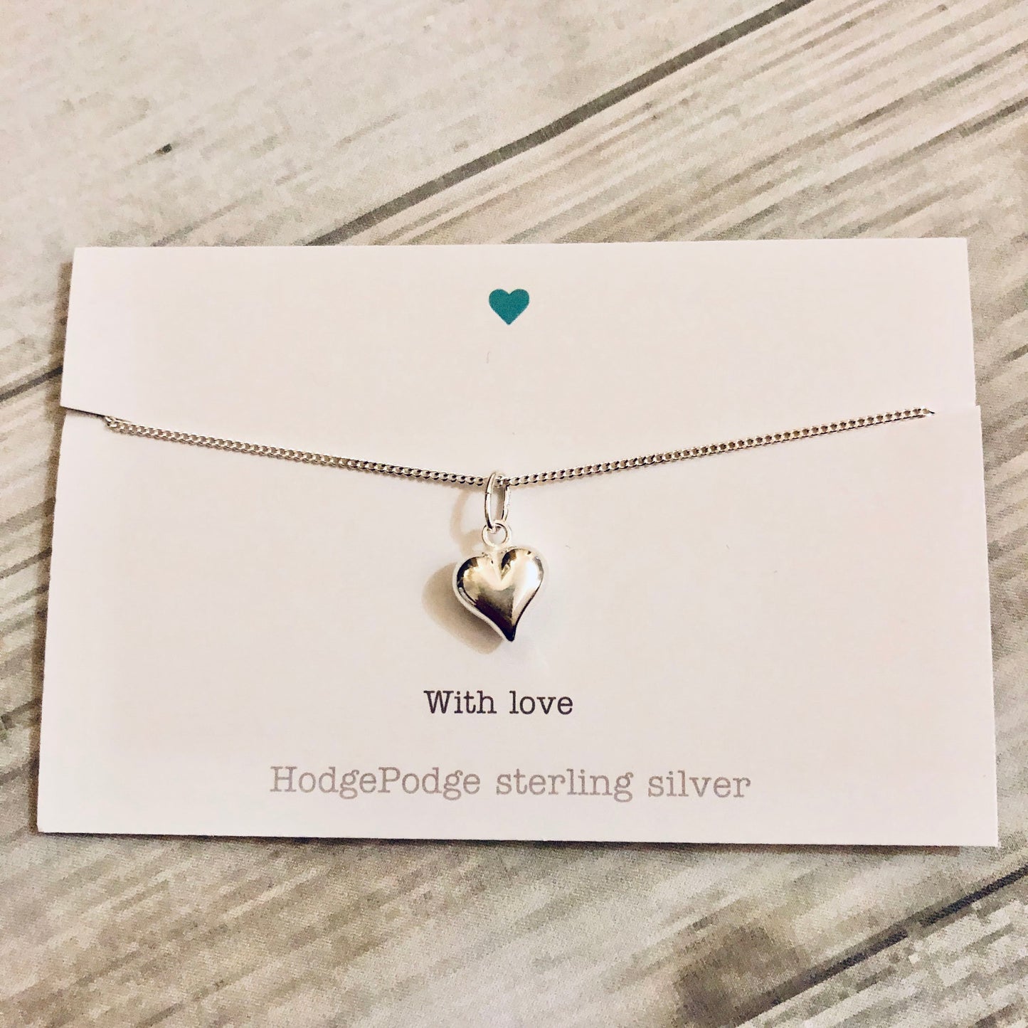 Sterling silver puff heart necklace.