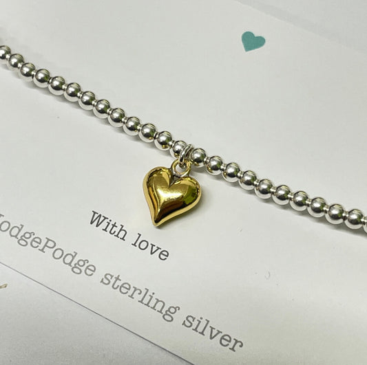 Sterling silver beaded bracelet with gold puff heart charm.