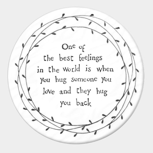 East of India round porcelain coaster. One of the best feelings in the world is when you hug someone you love and they hug you back.