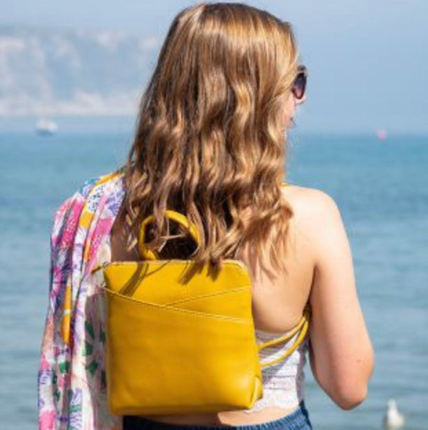 Mustard vegan leather crossover backpack by POM