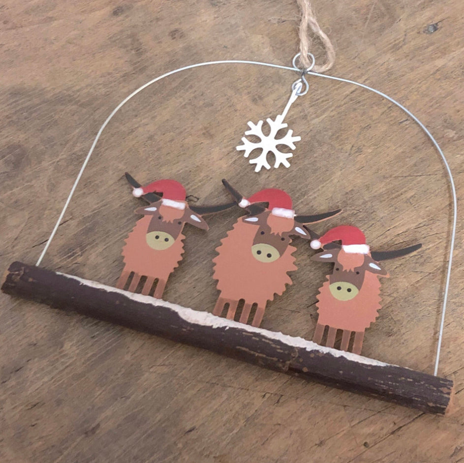 Three highland cows in Christmas hats, hanging decoration by Shoeless Joe