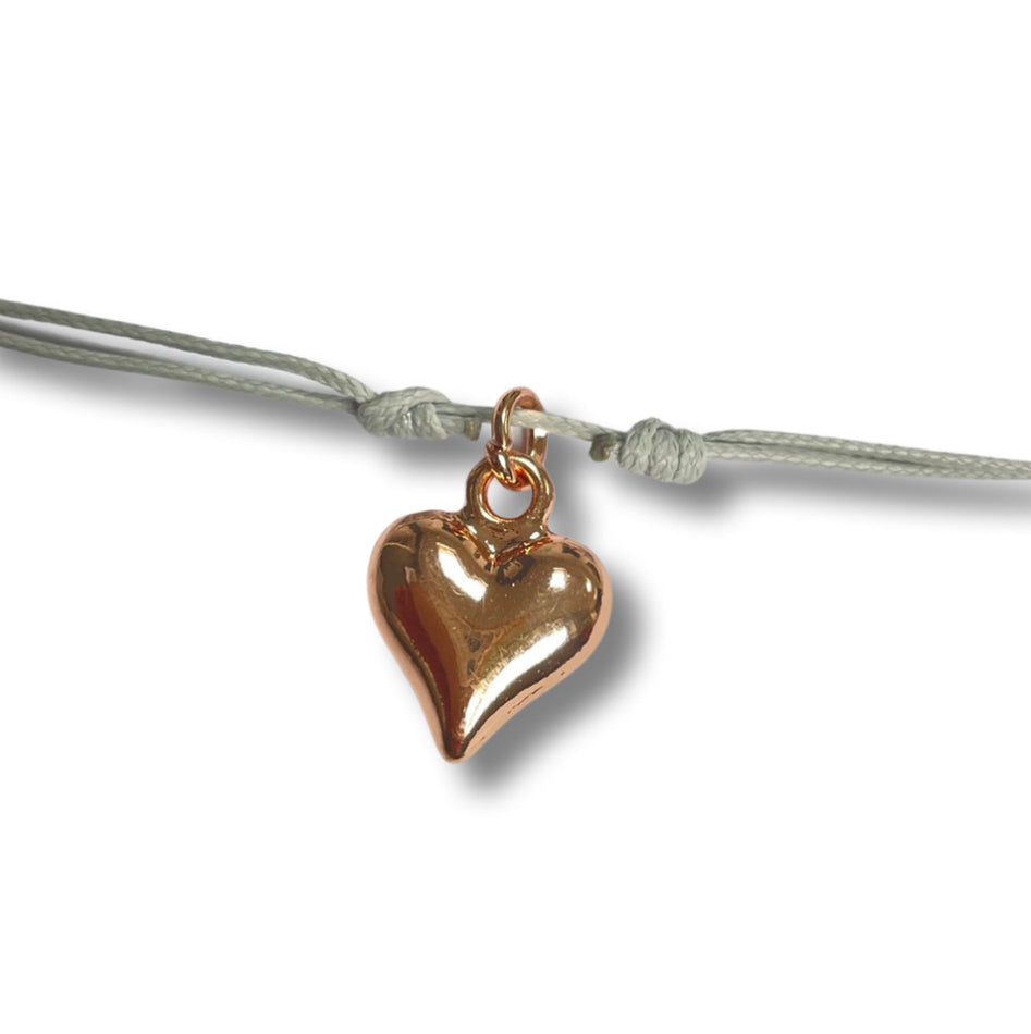 Adjustable cord bracelet with rose gold heart charm