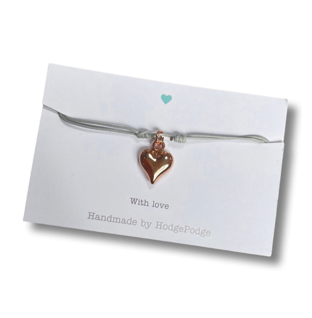 Adjustable cord bracelet with rose gold heart charm