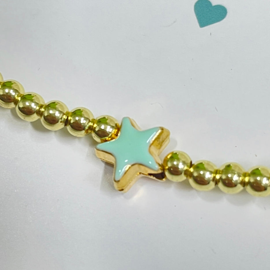 Gold bead bracelet with a jade enamel star.