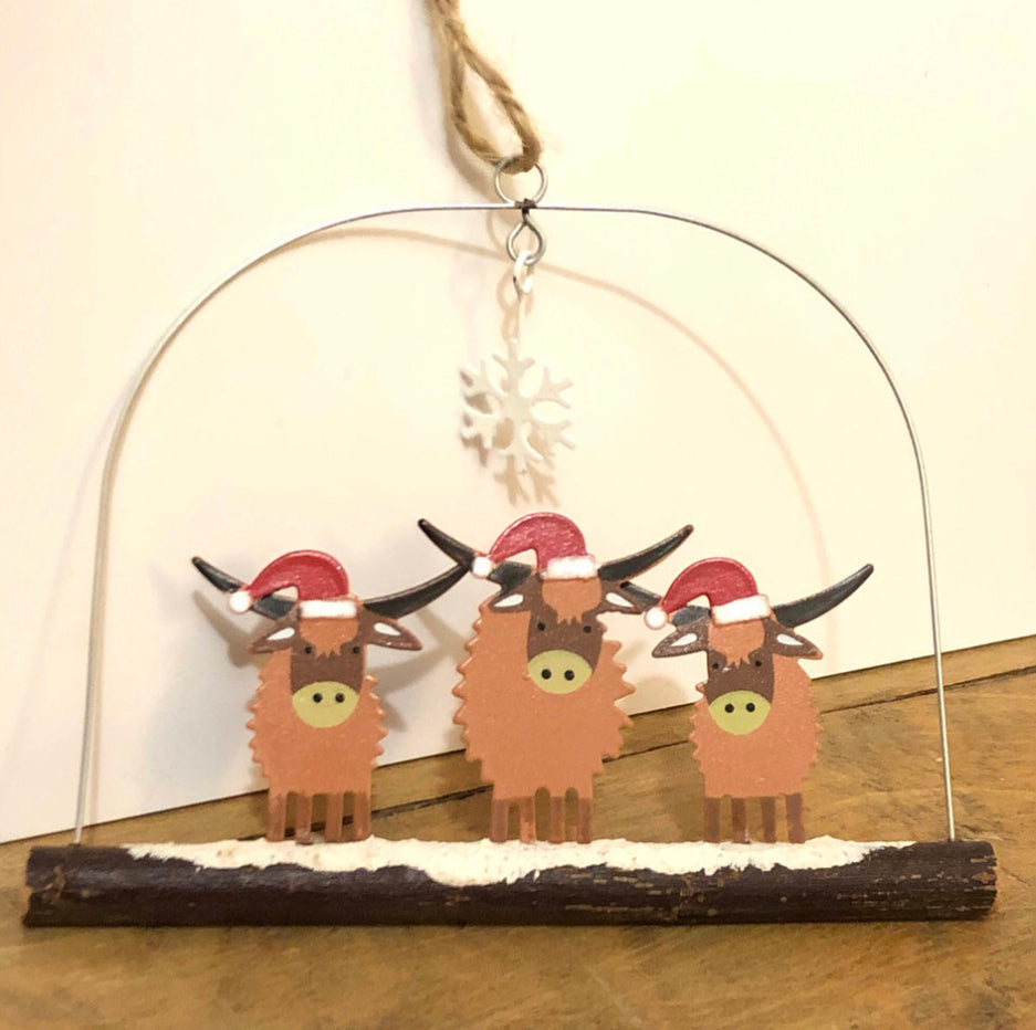 Three highland cows in Christmas hats, hanging decoration by Shoeless Joe