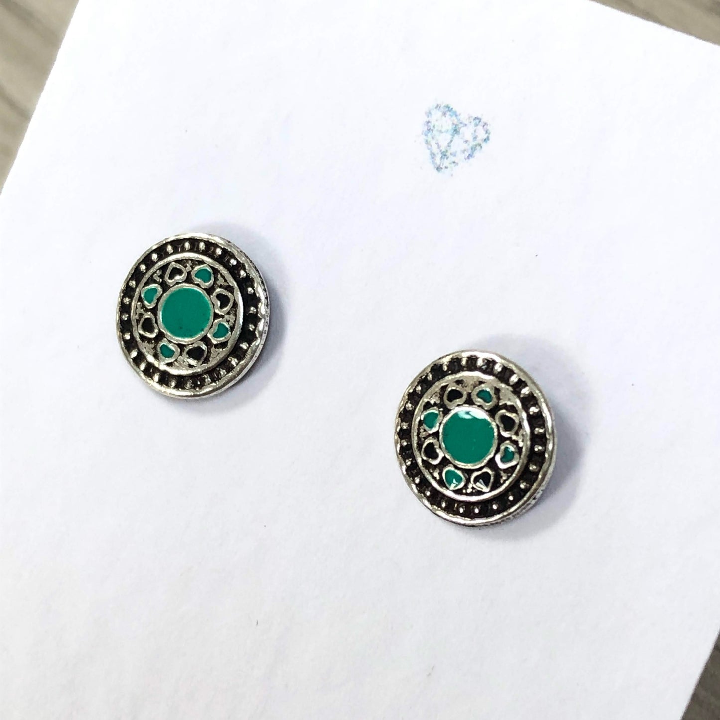 Sterling silver circle stud earrings with enamel detail. Geometric stud designs.