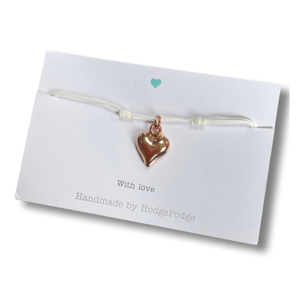 Adjustable cord bracelet with rose gold heart charm